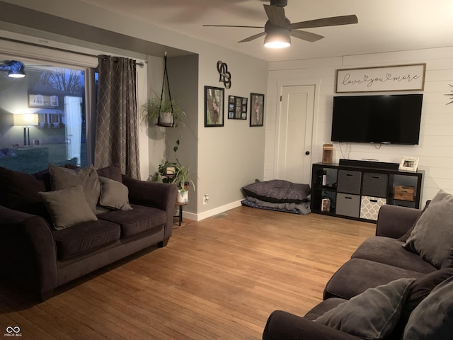 living room featuring ceiling fan and light wood-type flooring