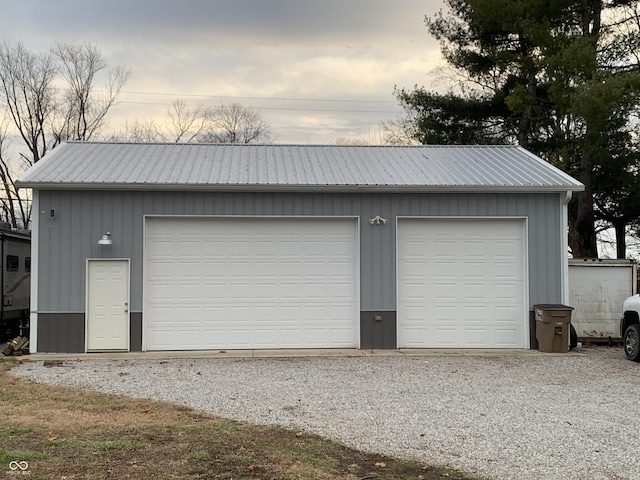 view of garage at dusk