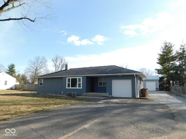 ranch-style home featuring a garage and a front lawn