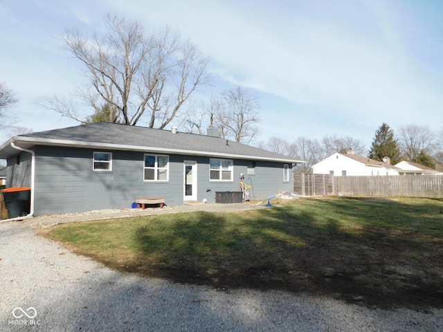 rear view of property with a yard