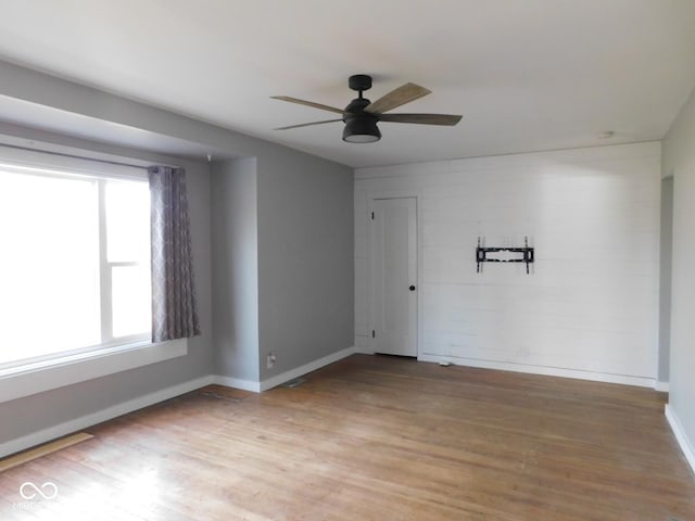 empty room with wood-type flooring and ceiling fan