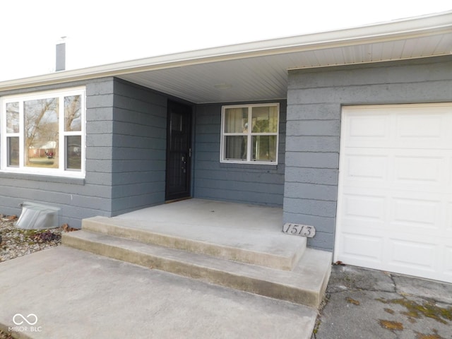 doorway to property with a garage