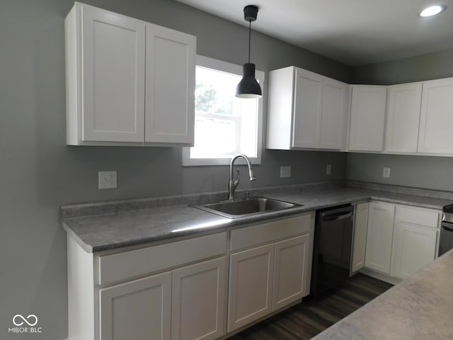 kitchen featuring black dishwasher, sink, and white cabinets