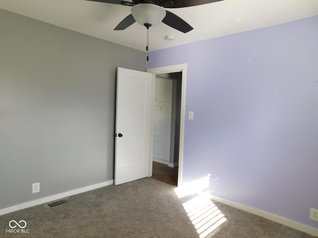 carpeted spare room with ceiling fan