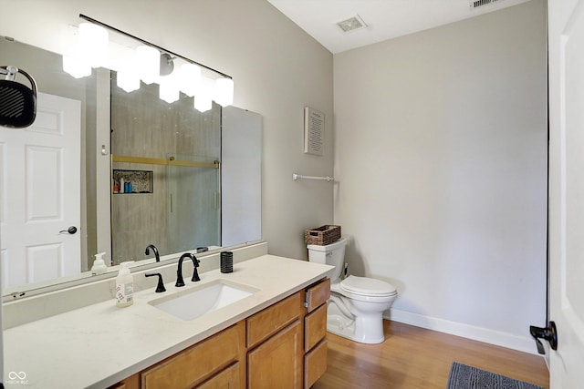 bathroom featuring hardwood / wood-style floors, vanity, and toilet