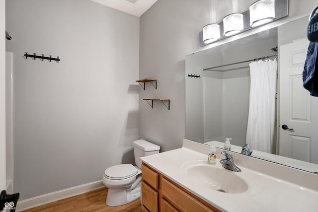 bathroom featuring a shower with shower curtain, vanity, hardwood / wood-style flooring, and toilet