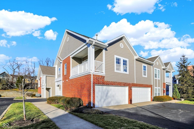 view of side of home with a balcony and a garage