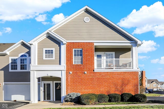 view of front of home featuring a balcony and a garage