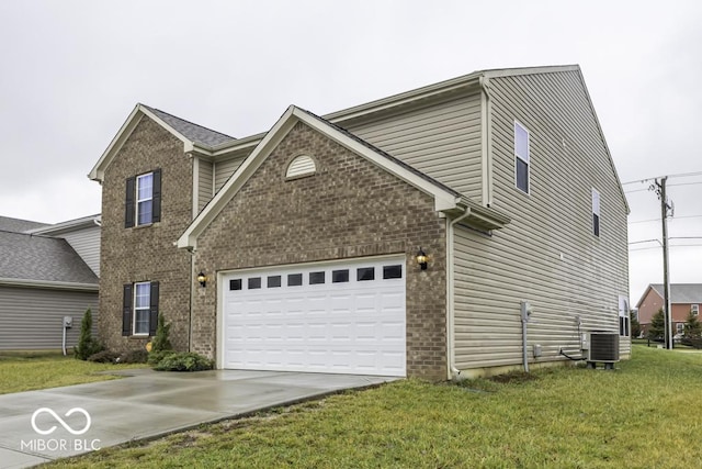 view of front of house featuring central AC unit, a garage, and a front lawn