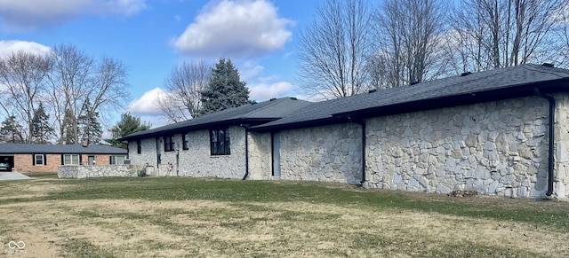 view of side of home featuring a yard