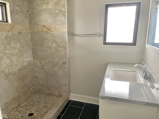 bathroom featuring walk in shower, vanity, and tile patterned floors