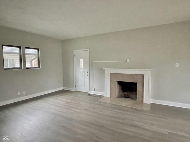 unfurnished living room featuring a fireplace and light hardwood / wood-style flooring