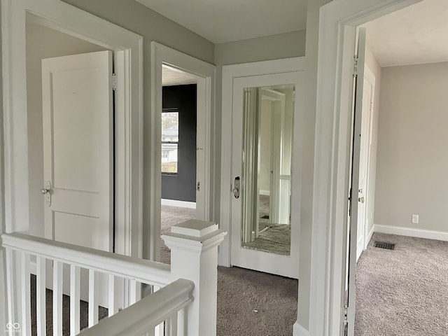 hallway with carpet floors