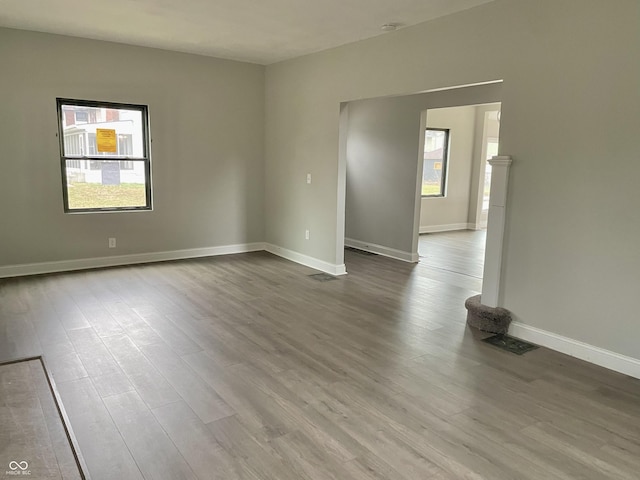 spare room featuring wood-type flooring