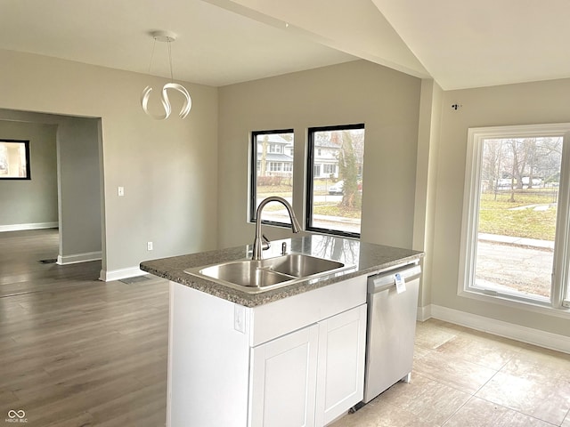 kitchen featuring a center island with sink, stainless steel dishwasher, white cabinets, and sink