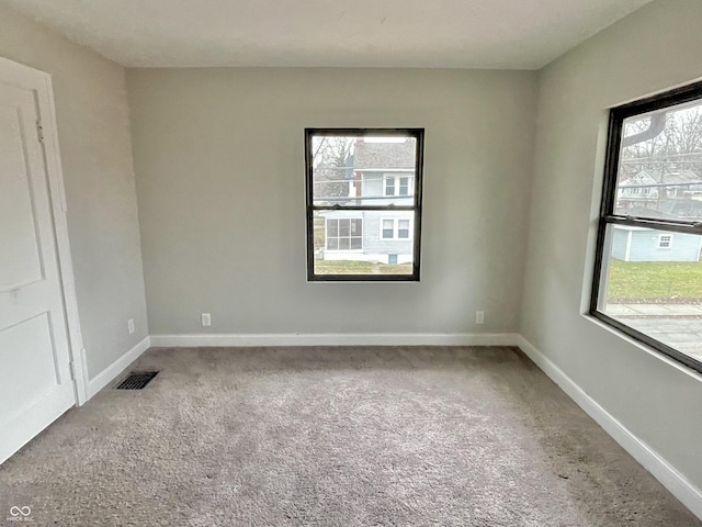 unfurnished room featuring light colored carpet