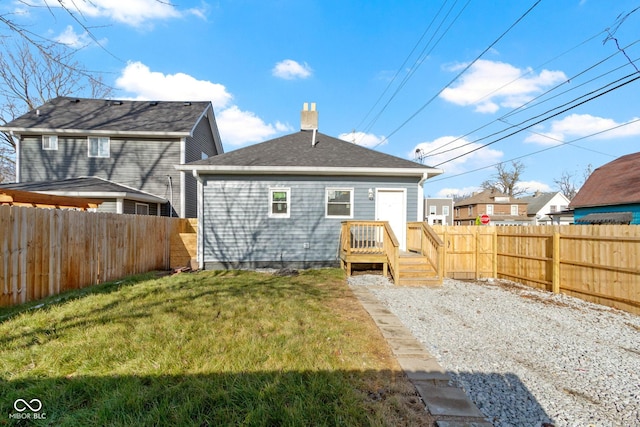 back of house featuring a lawn