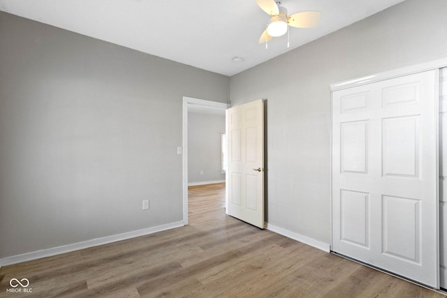 unfurnished bedroom featuring ceiling fan and light wood-type flooring