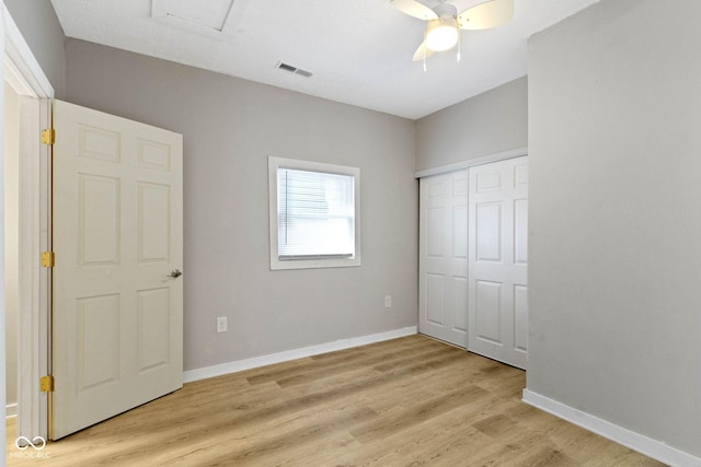 unfurnished bedroom featuring ceiling fan, light hardwood / wood-style flooring, and a closet