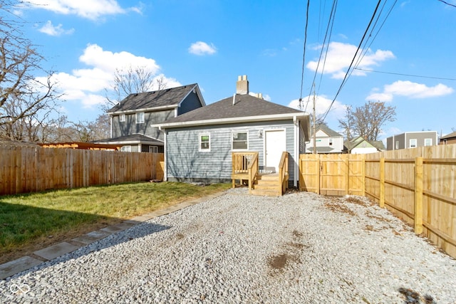 rear view of property with a lawn