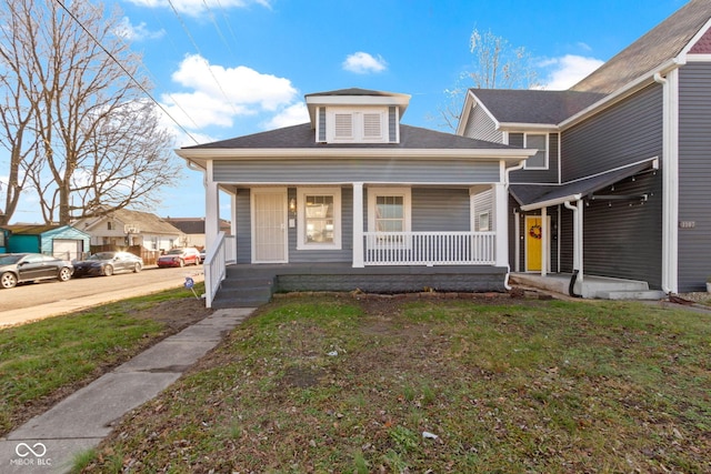 bungalow-style house featuring a front lawn and covered porch