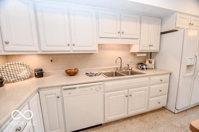 kitchen with white cabinets, white appliances, and sink