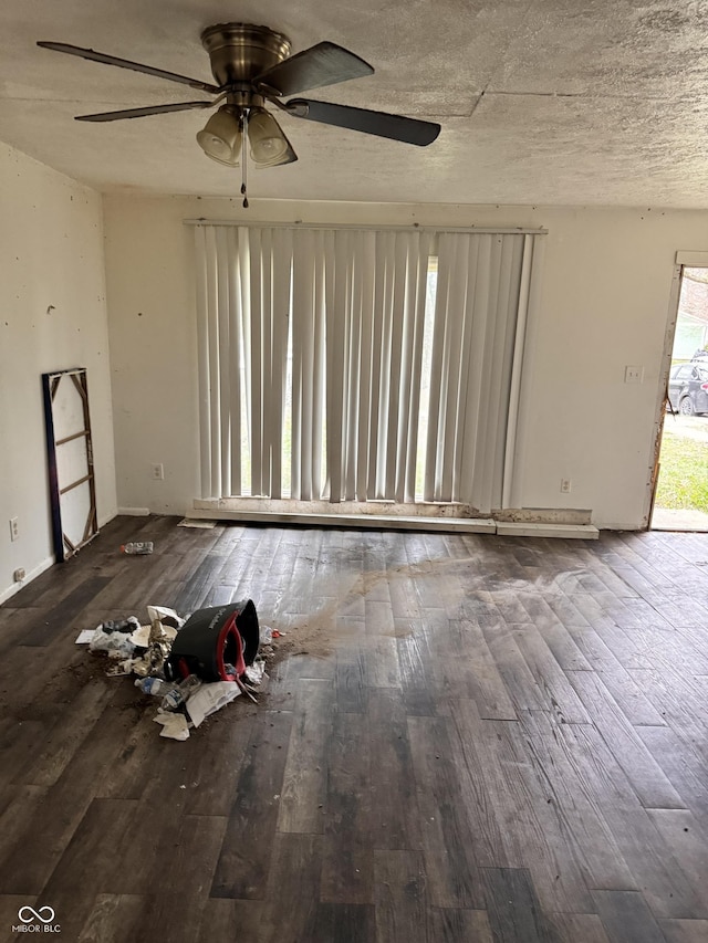 empty room with ceiling fan, a textured ceiling, and hardwood / wood-style flooring