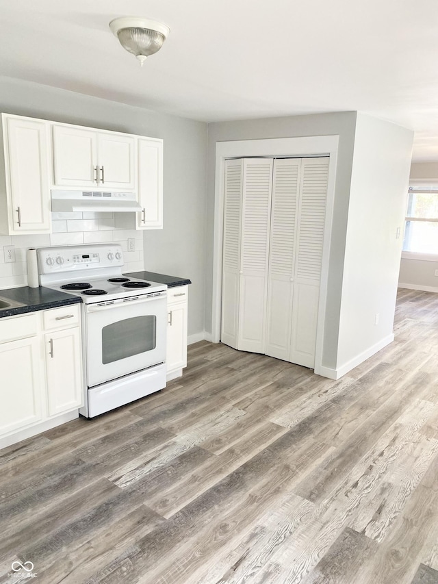 kitchen featuring decorative backsplash, electric range, light hardwood / wood-style flooring, and white cabinetry