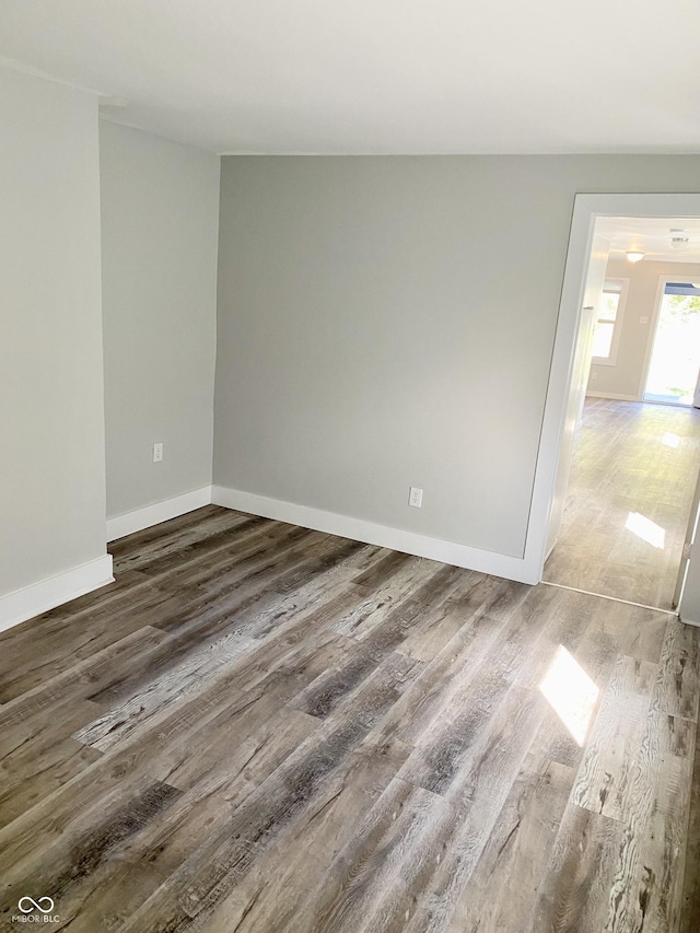 empty room with dark hardwood / wood-style flooring