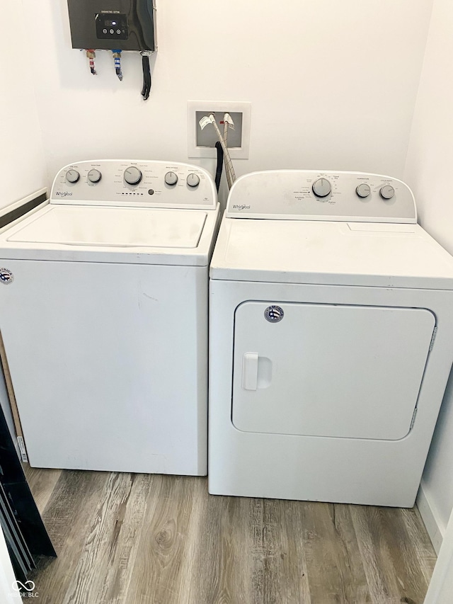 washroom with wood-type flooring and separate washer and dryer