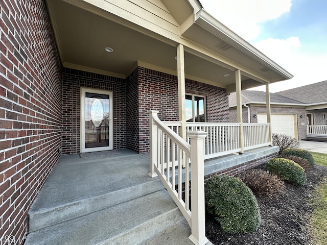 property entrance with a garage and covered porch