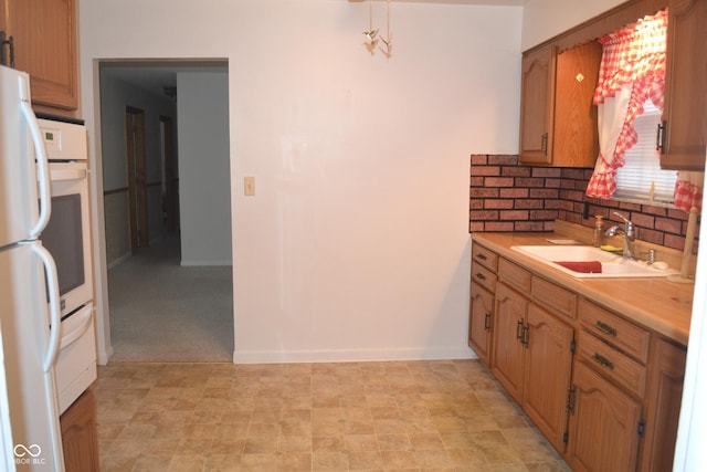 kitchen featuring backsplash, sink, and light colored carpet