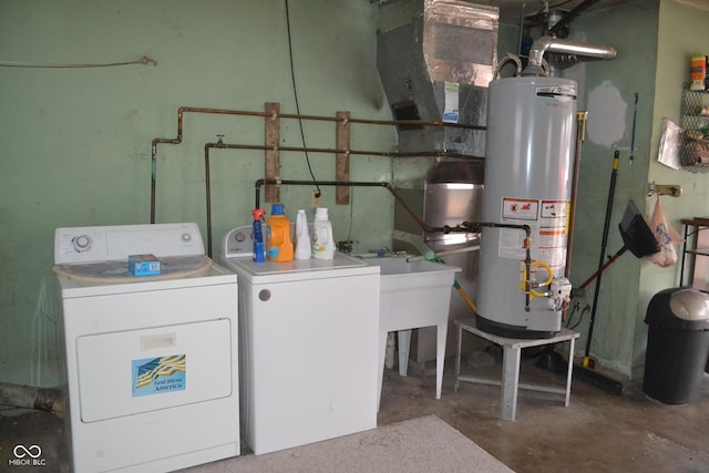 clothes washing area with washer and dryer and gas water heater