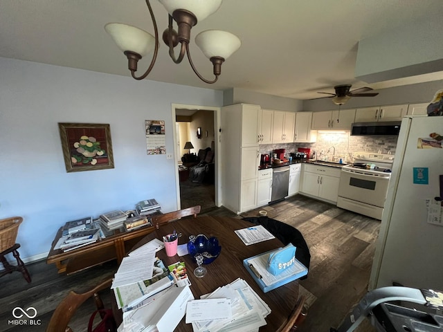 kitchen with white cabinetry, dark wood-type flooring, tasteful backsplash, white refrigerator, and electric stove