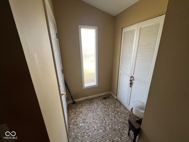 interior space with tile patterned flooring and vaulted ceiling