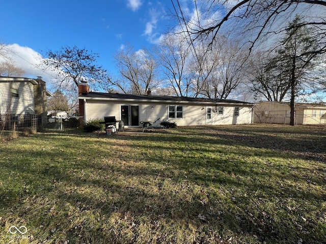 rear view of property with a lawn