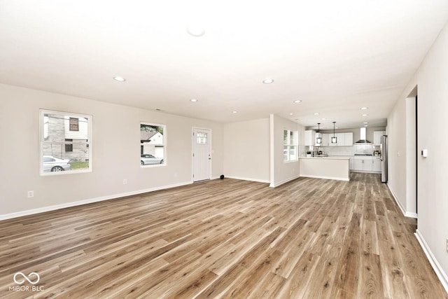 unfurnished living room with light hardwood / wood-style flooring