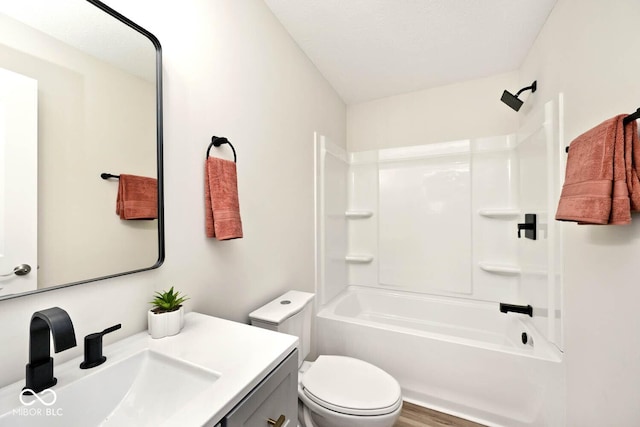 full bathroom featuring wood-type flooring, vanity, toilet, and tub / shower combination