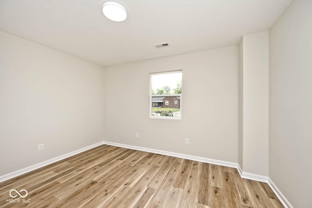 empty room with light hardwood / wood-style flooring