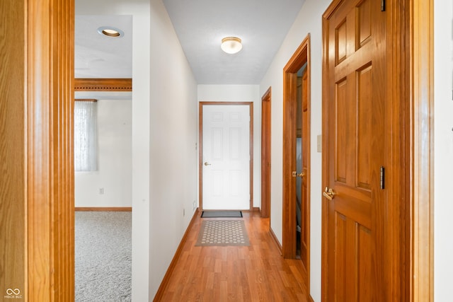 hallway with light hardwood / wood-style floors