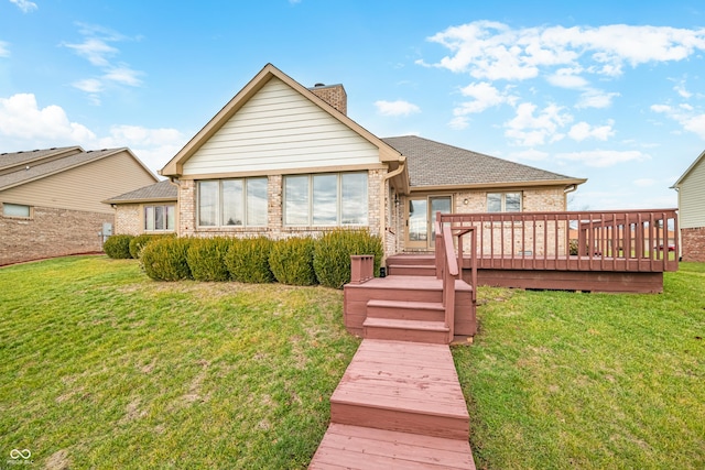 back of house featuring a wooden deck and a lawn