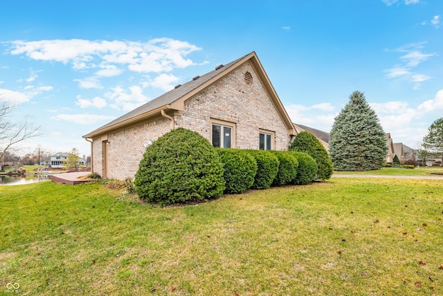 view of property exterior featuring a lawn and a water view