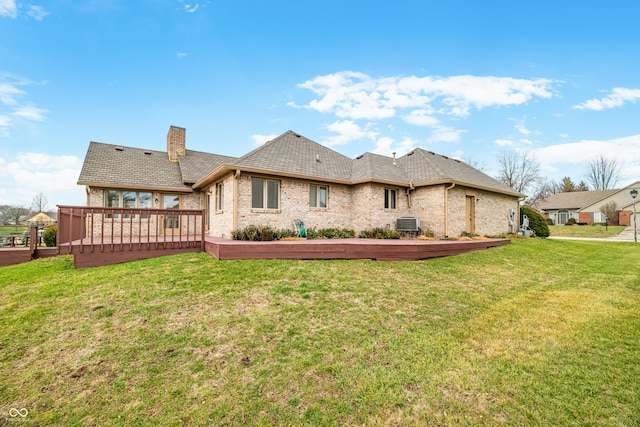 rear view of house featuring a wooden deck, a yard, and central AC unit