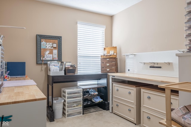 office with a workshop area and light colored carpet