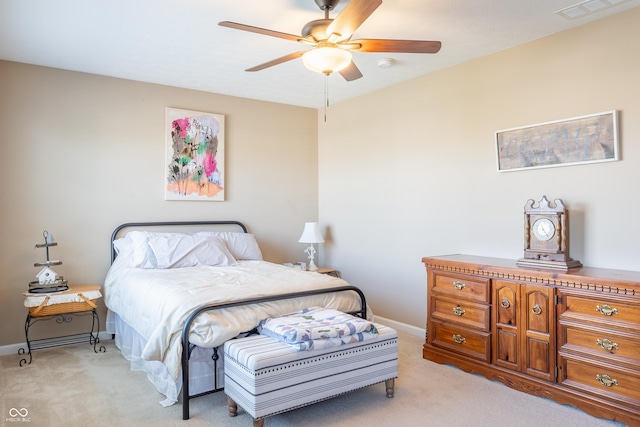 bedroom with ceiling fan and light carpet