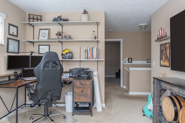 home office featuring light colored carpet and a textured ceiling