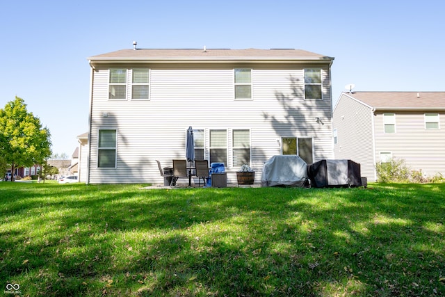 back of house featuring a yard