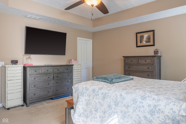 carpeted bedroom with a textured ceiling and ceiling fan