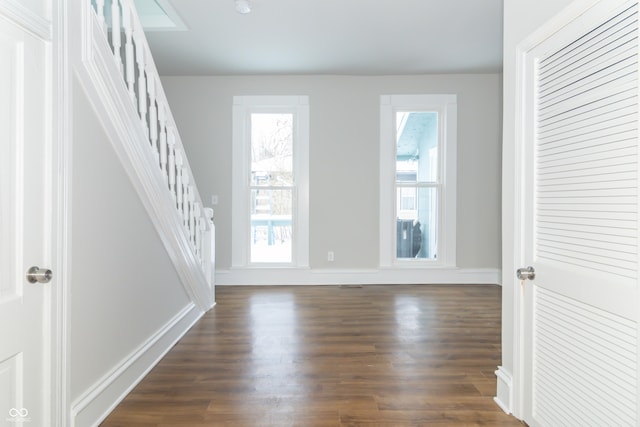 interior space with dark hardwood / wood-style floors and a wealth of natural light