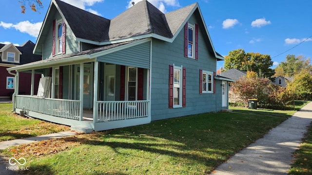 view of property exterior featuring a porch and a lawn